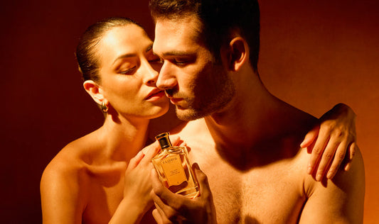 A lady embracing a man holding a bottle of Golden Amber