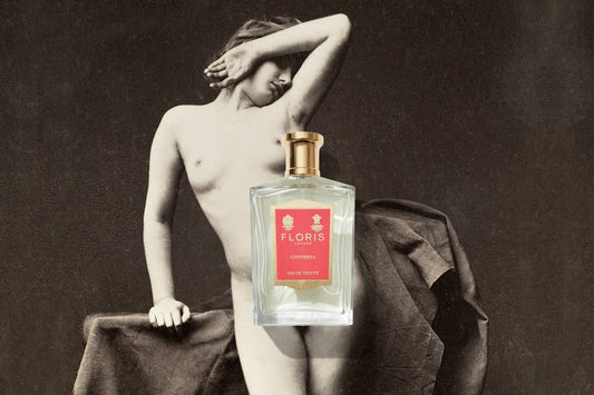 A vintage picture of a nude woman leaning on a plinth, collaged on top is a bottle of Floris London's Chypress fragrance with a pink label. 