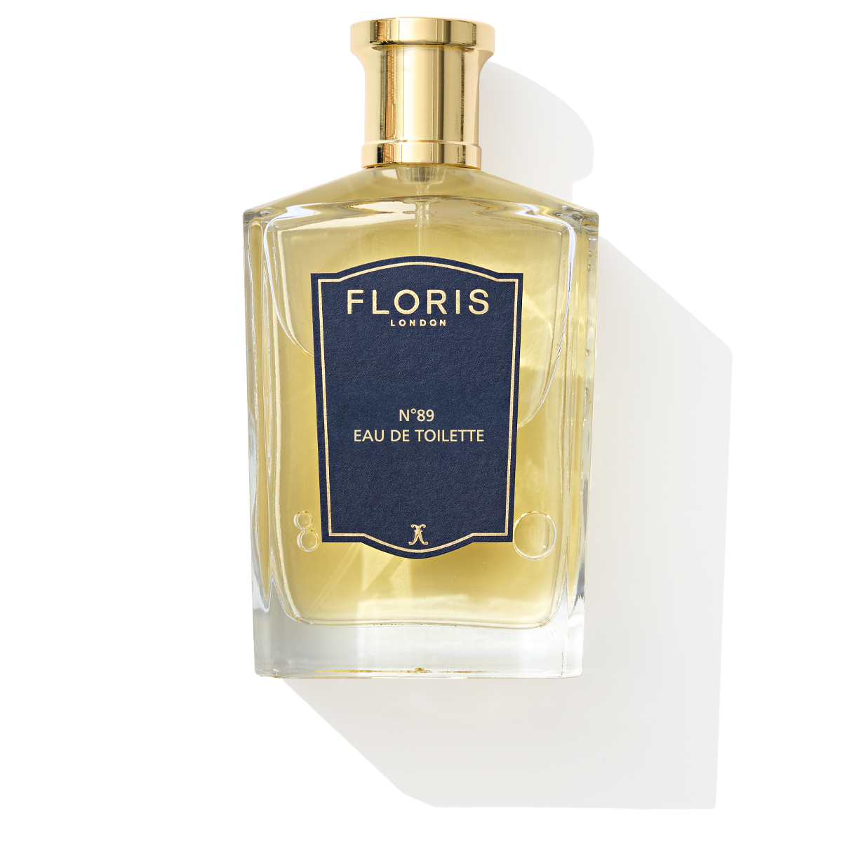 Floris London's No. 89 Eau de Toilette features orange and bergamot notes in a clear glass bottle with a gold cap and navy blue label.