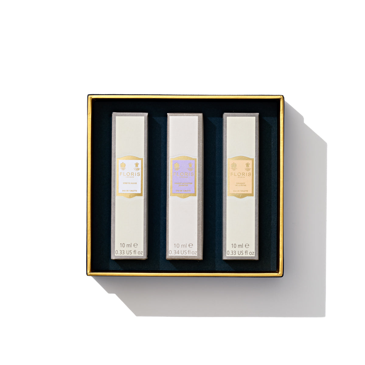 Introducing the "Perfumer's Trilogy: For Her" by Floris London – a luxurious boxed set of three exquisite perfume bottles, featuring floral fragrances for her and elegantly displayed against a white background—the perfect choice for the season of celebration.