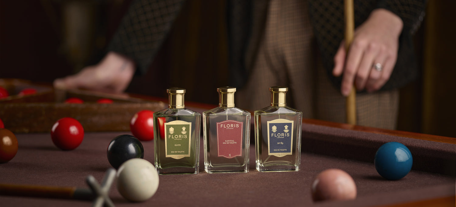 Floris London mens fragrances Elite, Santal and No. 89 placed upon a red snooker table surrounded by snooker balls.