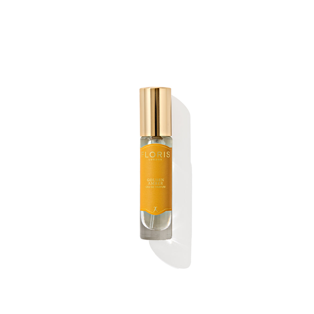 A perfume bottle with a gold cap and a yellow-orange label reading "Floris London," exudes the rich essence of Golden Amber - Eau de Parfum, isolated on a white background.