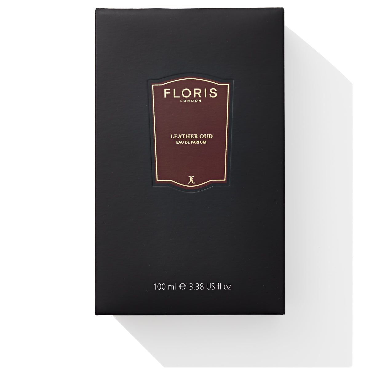 A black Floris London Leather Oud Eau de Parfum box, 100 ml, enriched with vetiver and oud oil, casts a shadow on a white background.