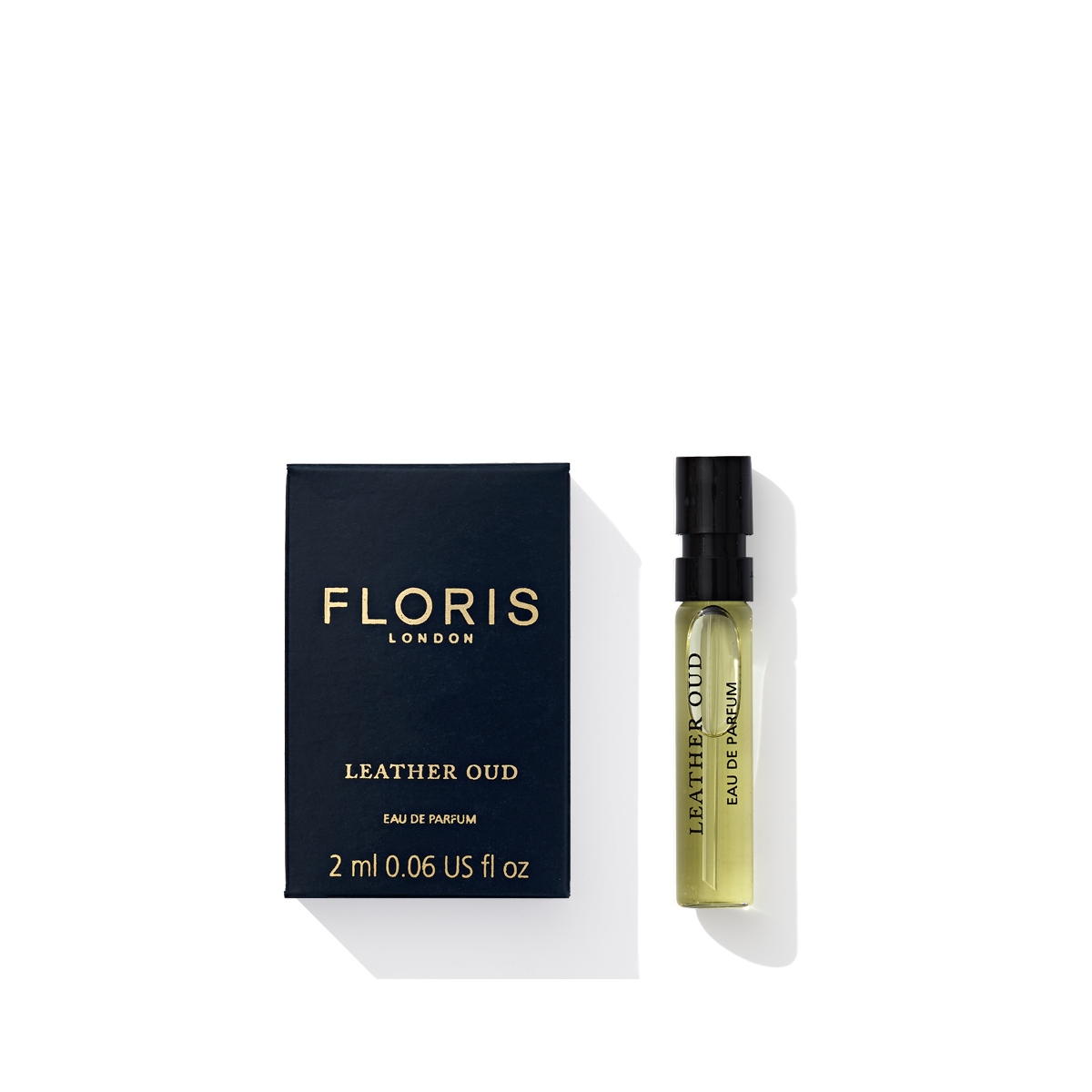 A 2ml bottle of Floris London's Leather Oud Eau de Parfum with rich oud oil comes next to its navy blue box.