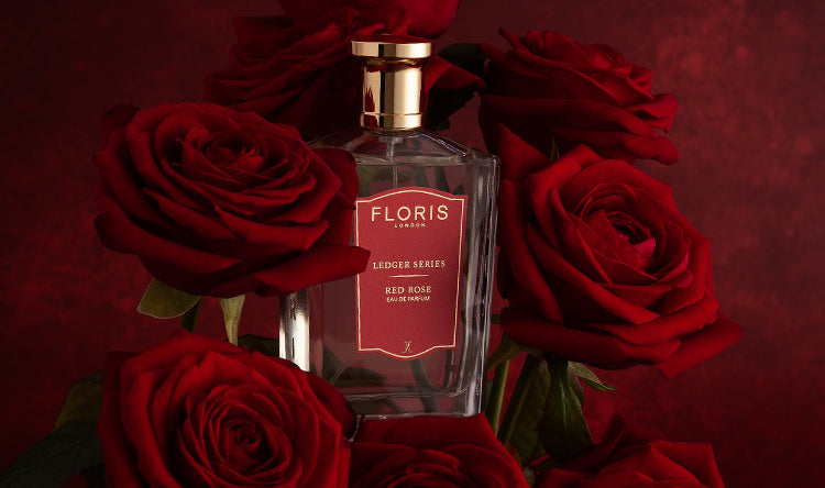 A bottle of Floris London Red Rose surrounded by Red Roses.