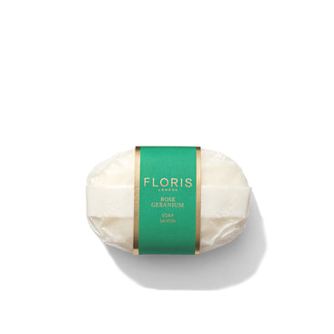 A bar of Floris London Rose Geranium Soap wrapped in elegant green and gold packaging against a pristine white background.