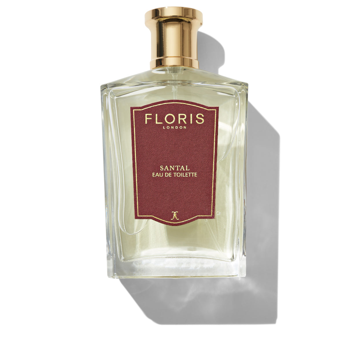 A bottle of Floris London Santal - Eau de Toilette from the men's signature collection, featuring a red label and a gold cap, embodying a refined woody fougère essence.