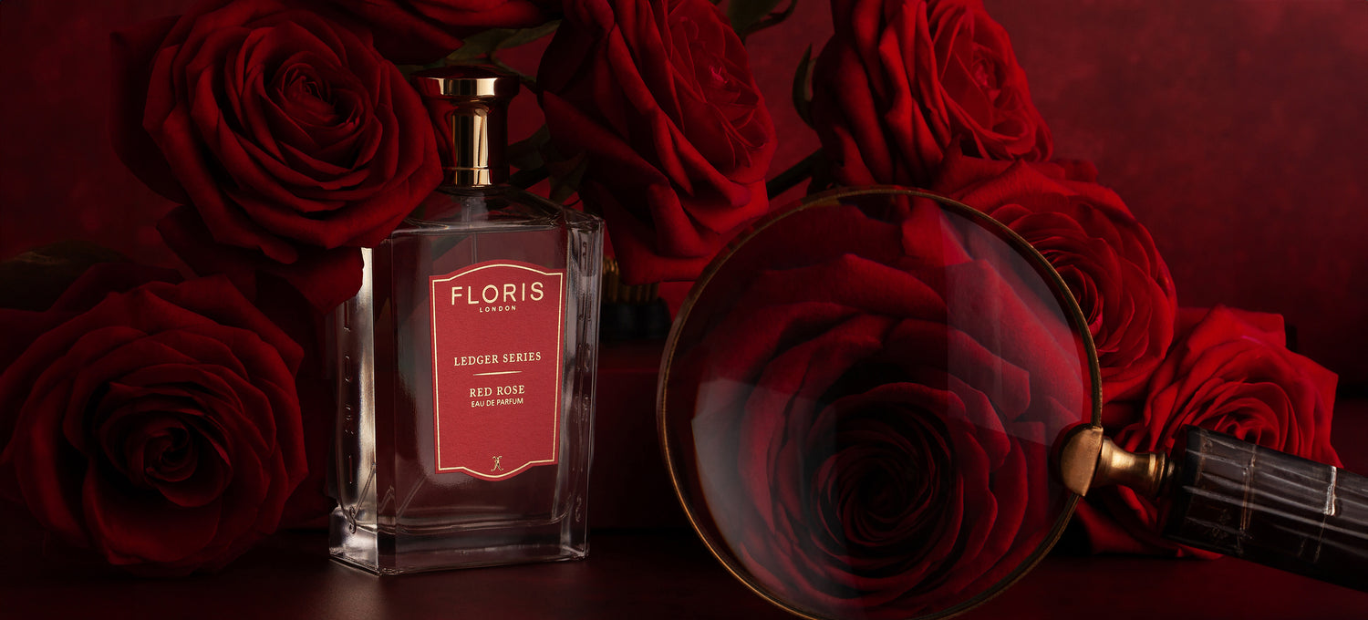 A bottle of Floris London Red Rose surrounded by Red Roses.