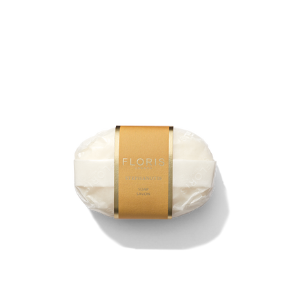 A bar of Stephanotis Soap from Floris London, wrapped in paper with a brown Floris label in the center.